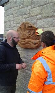 Rob and Lindsy putting up a carving near the car park.